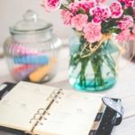 planner on desk with pink flowers