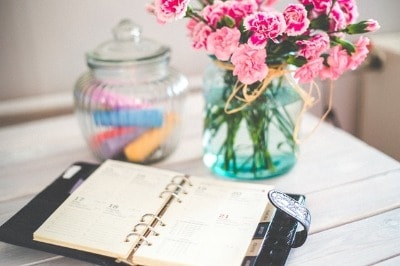 planner on desk with pink flowers